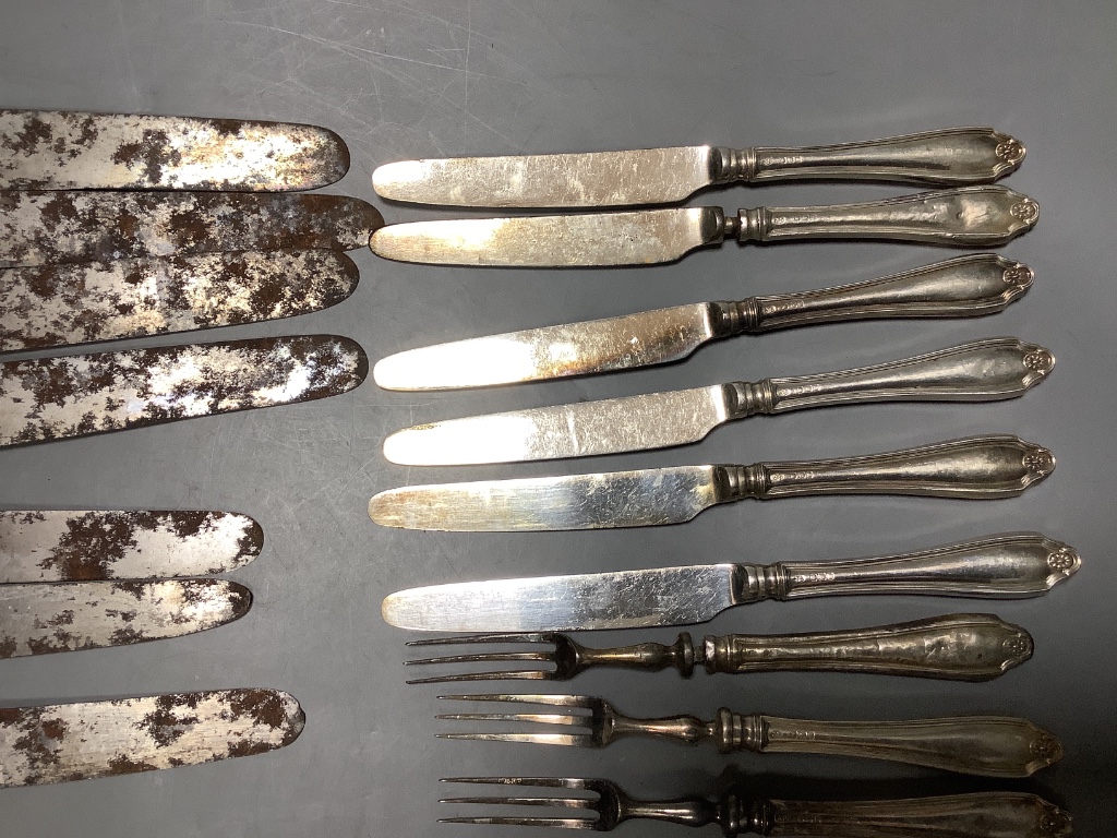 Four George IV silver handled table knives and four similar desert knives and a quantity of silver handled fruit knives and forks and two silver butter knives.